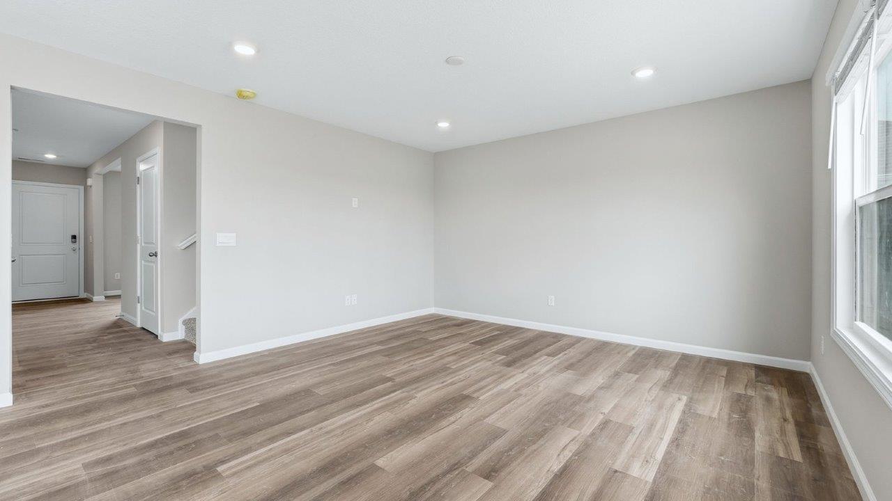 living room with mohawk eastmont lvp and popular grey walls. open concept to foyer, casual dining, and kitchen