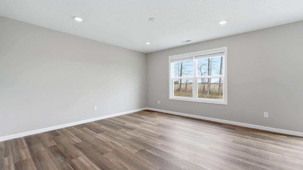 living room with mohawk eastmont lvp and popular grey walls. open concept to foyer, casual dining, and kitchen
