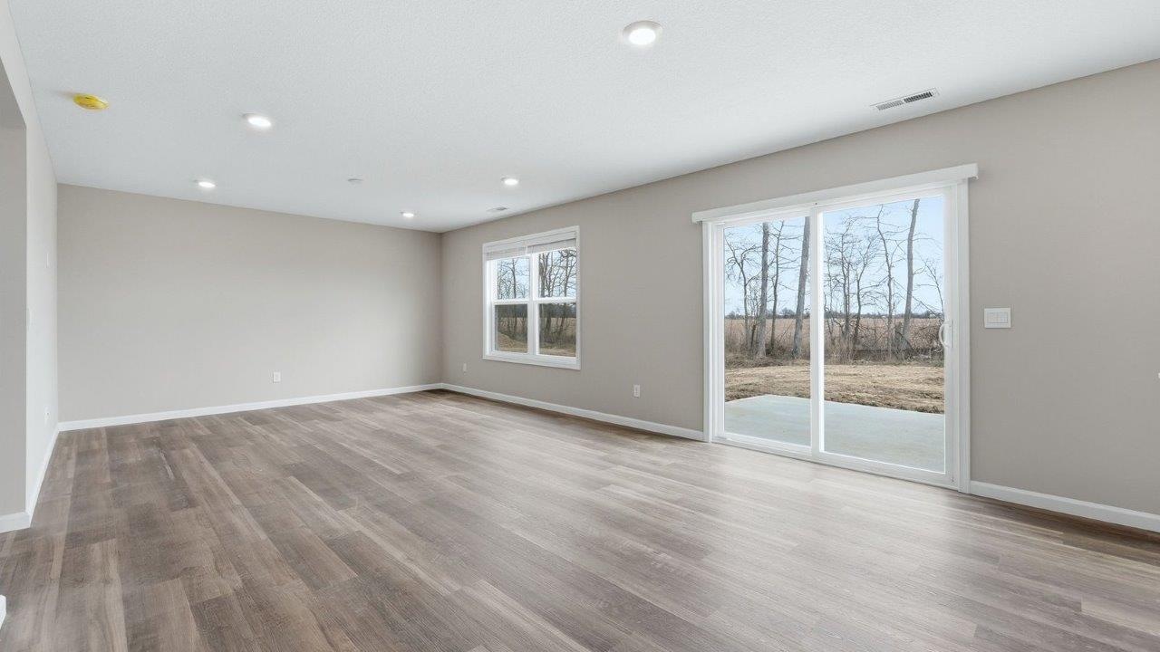 casual dining space with mohawk eastmont lvp flooring and sliding door to backyard patio