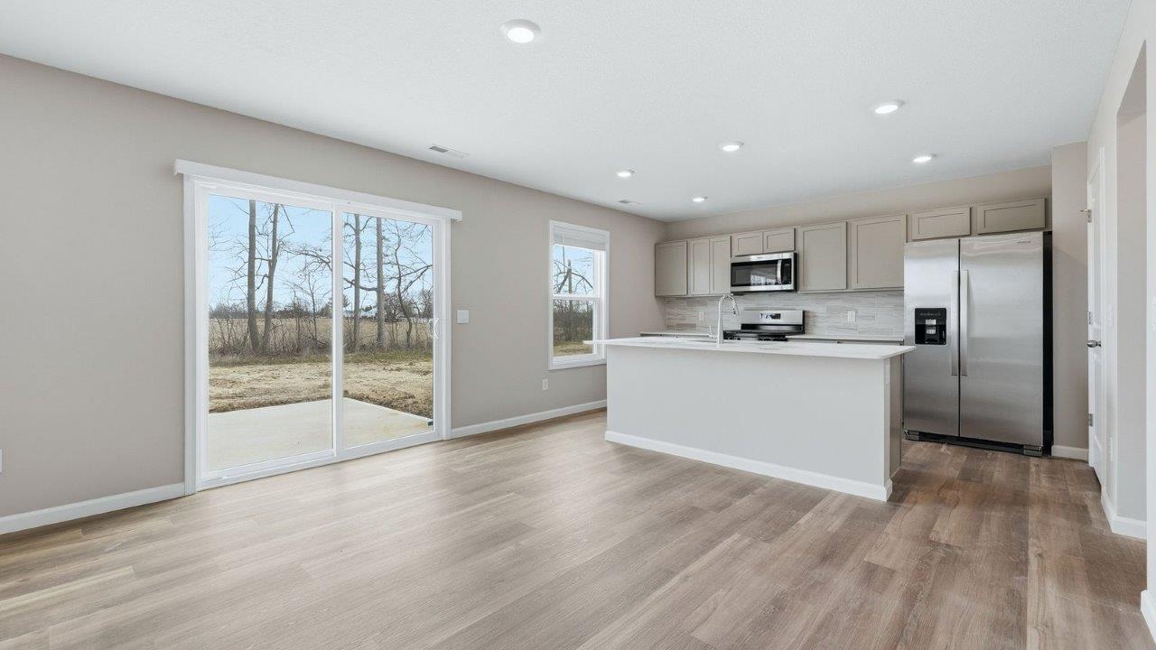 casual dining space with mohawk eastmont lvp flooring and sliding door to backyard patio