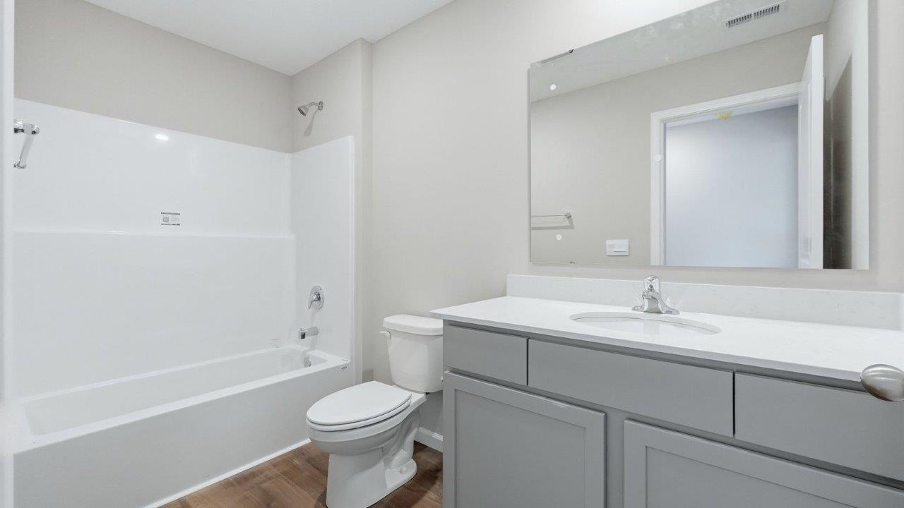 full bathroom with single sink vanity and tub shower