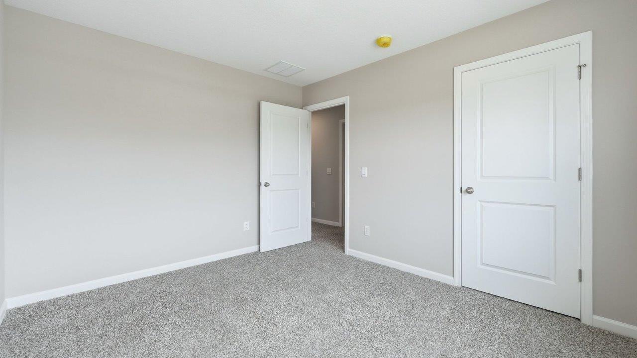 bedroom 3 with beige carpet, 1 windows, closet, and popular grey walls