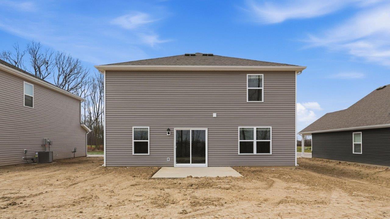 rear exteriuor with concrete patio and spacious yard