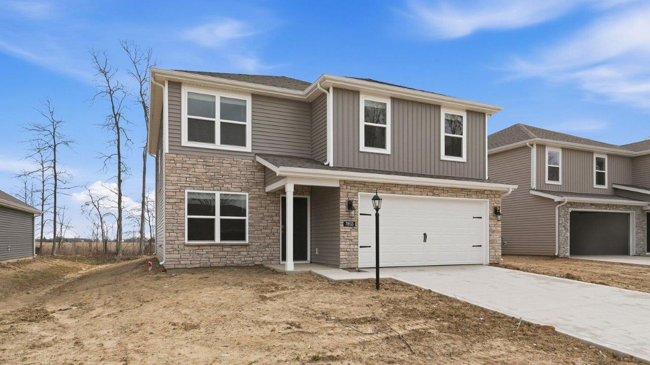 bellamy exterior- covered porch, 2 car garage, harvard slate siding, and colorado stone.