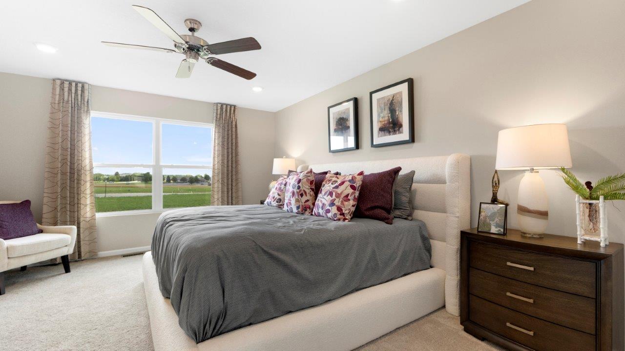 henley spacious primary bedroom with carpet, ceiling fan, and 2 windows