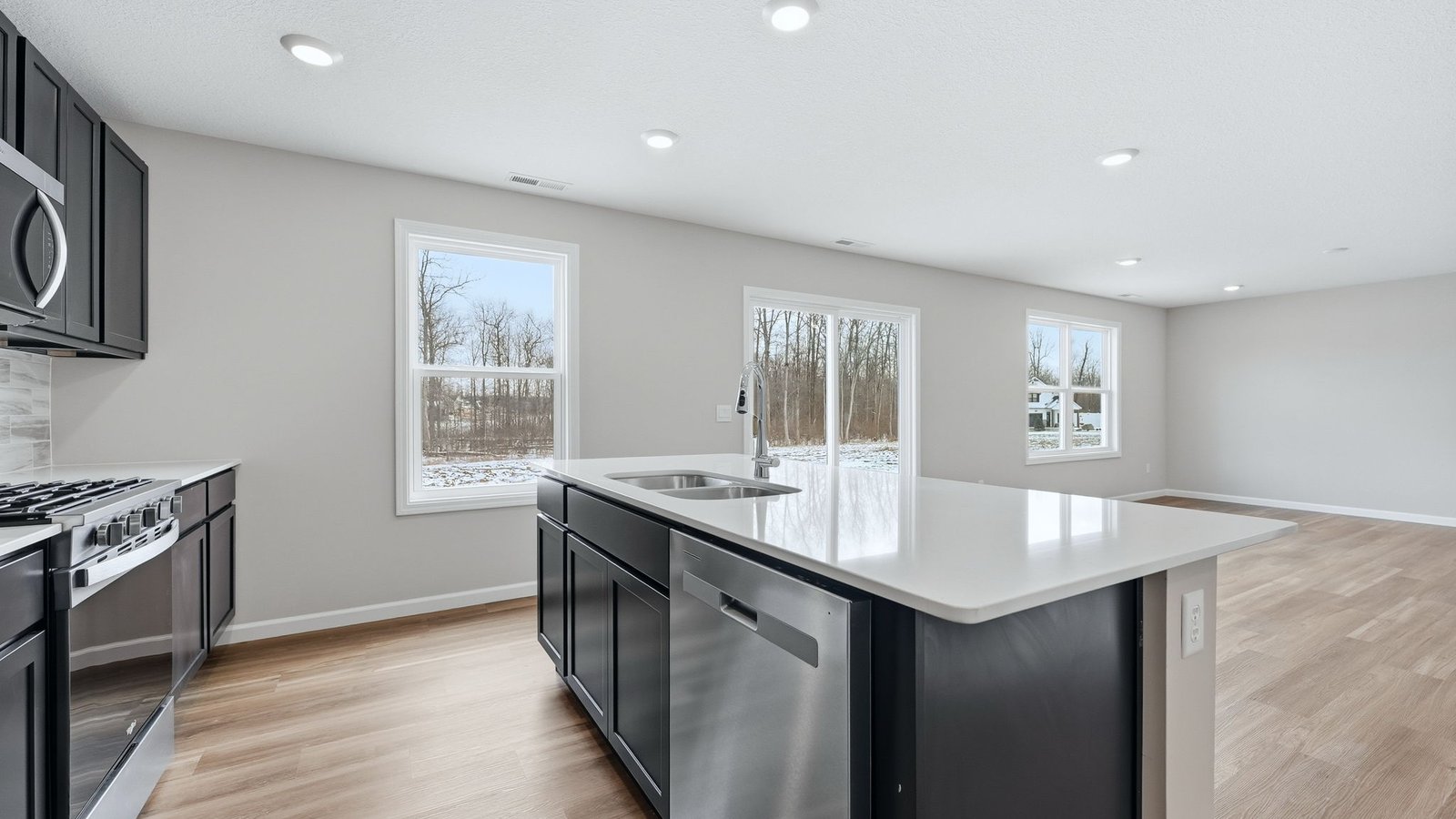 n the kitchen, you’ll find a large center island with bar seating, sleek quartz countertops, sarsaparilla shaker style cabinets, ceramic tile backsplash, and a walk-in pantry with the Freedom Rail system for extra storage.