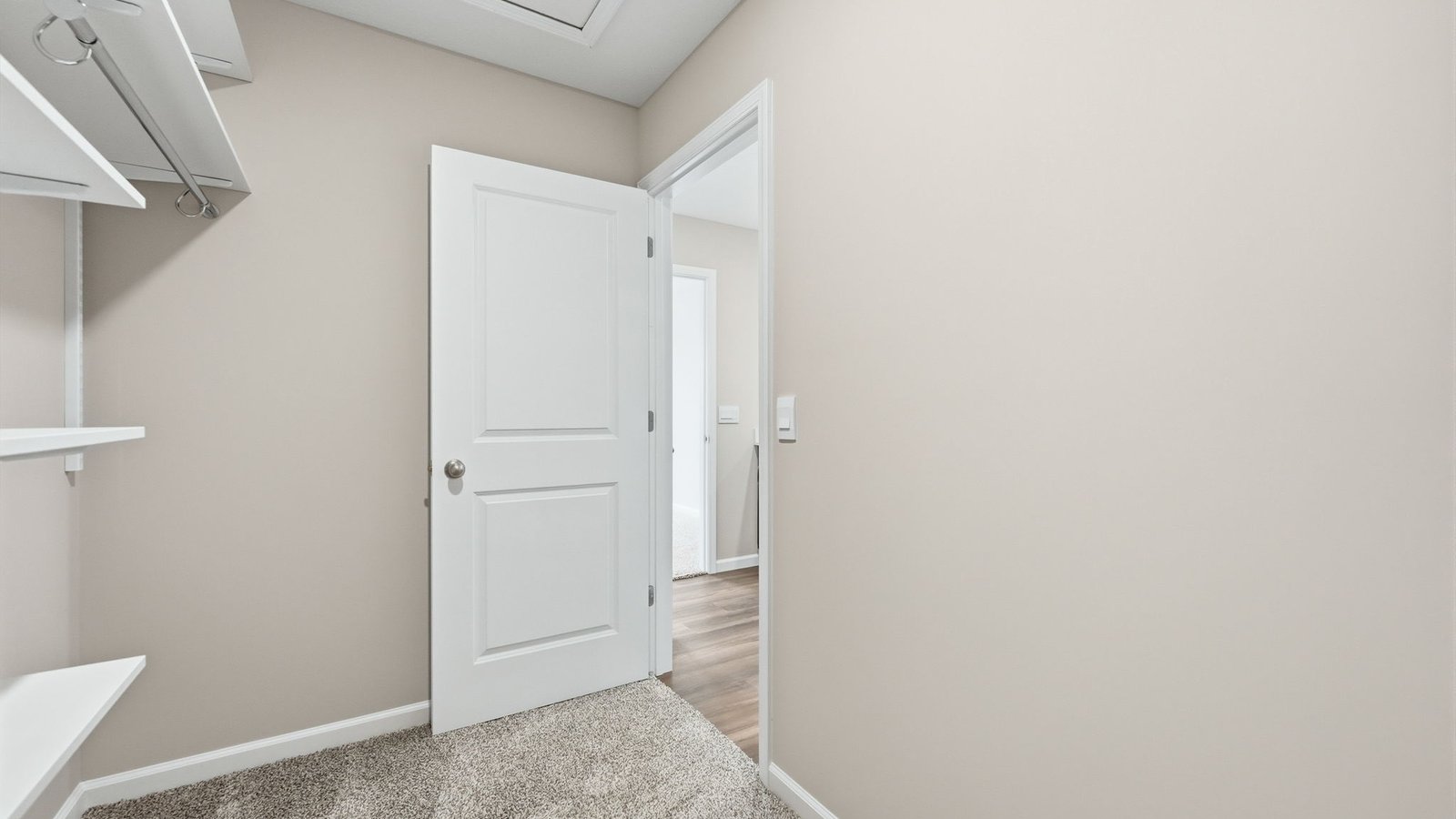 primary ensuite walk-in closet with shelving