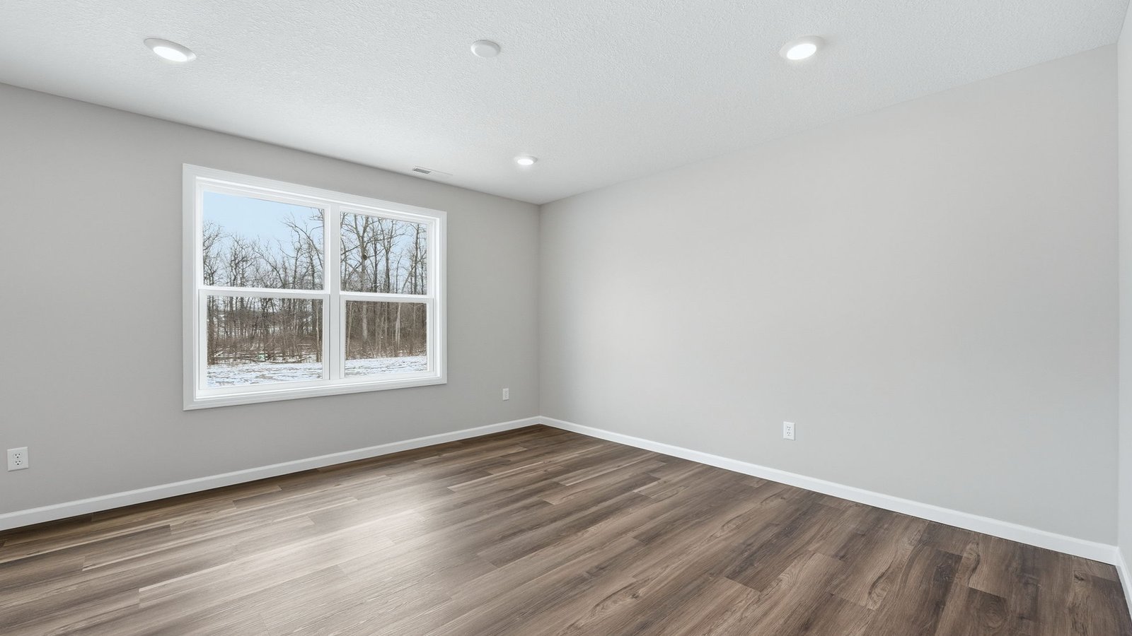 open concept living room with lvp flooring, popular grey walls, 2 windows