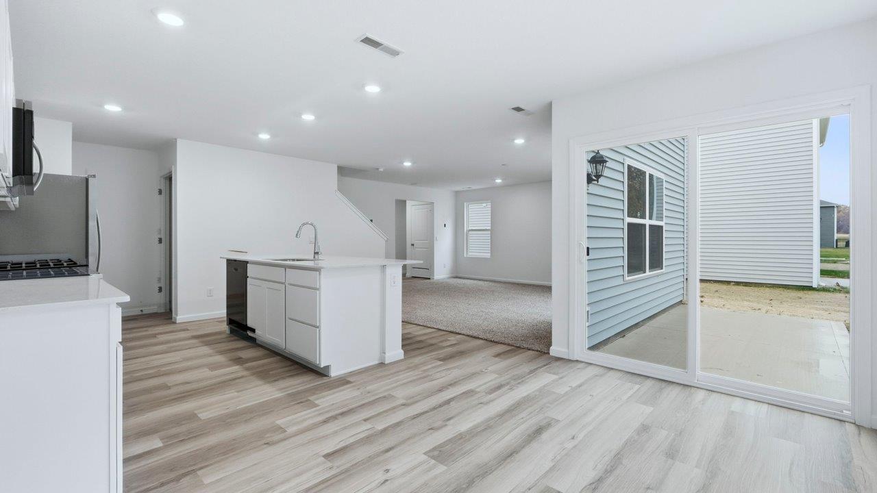 pine dining room with lvp with sliding door to patio