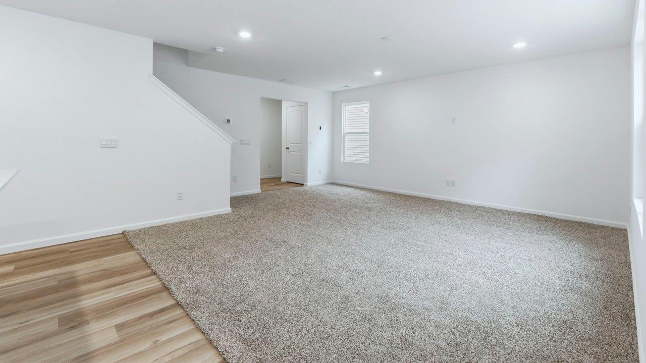 pine open layout living room with carpet