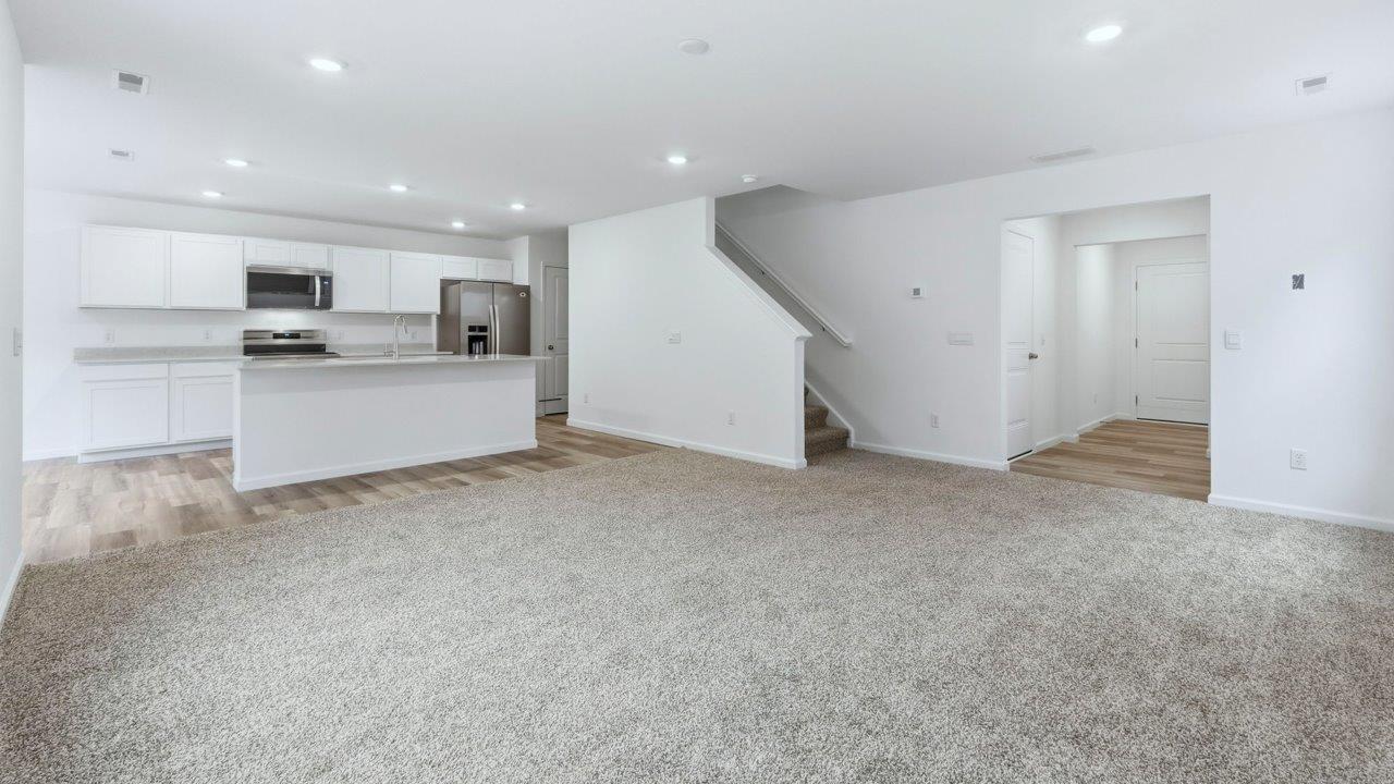 pine open layout living room with carpet