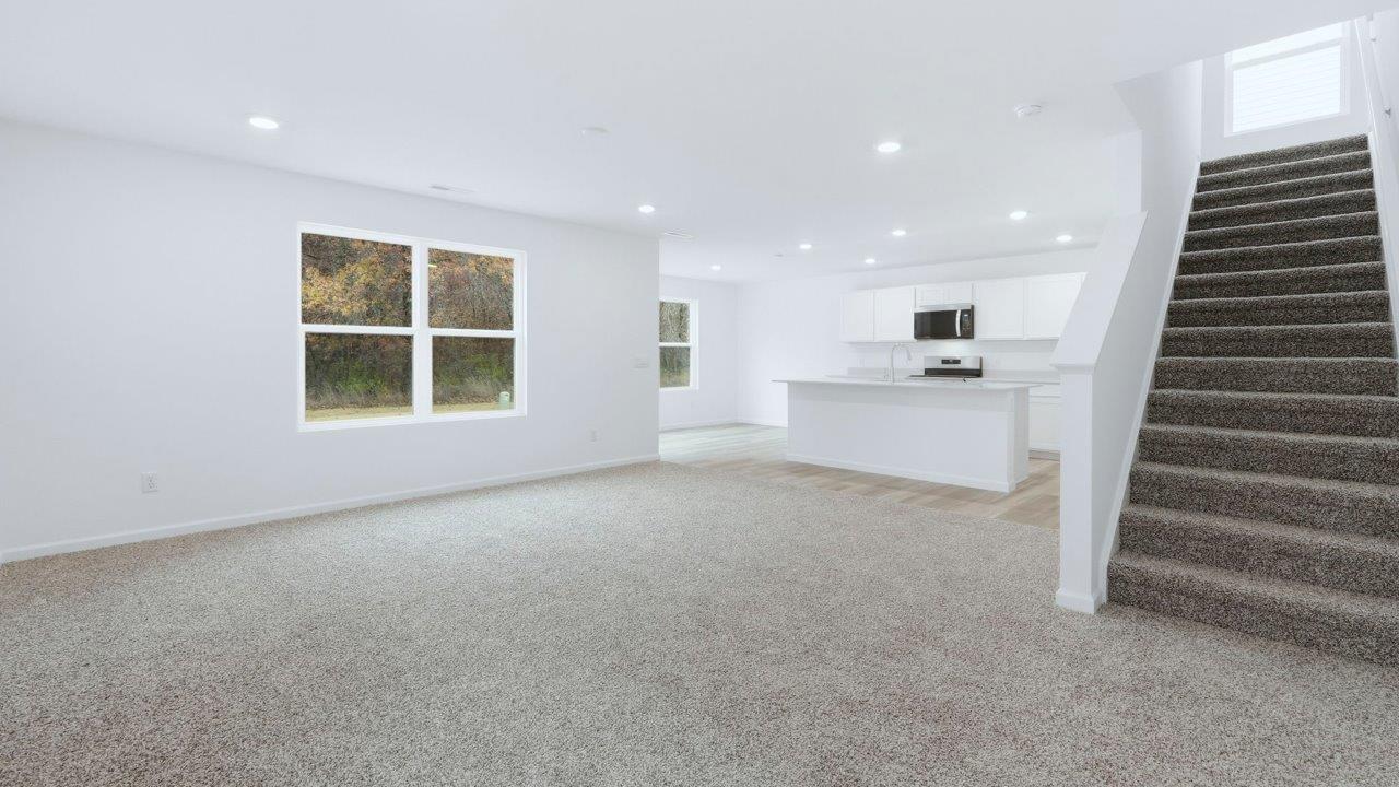 pine open layout living room with carpet