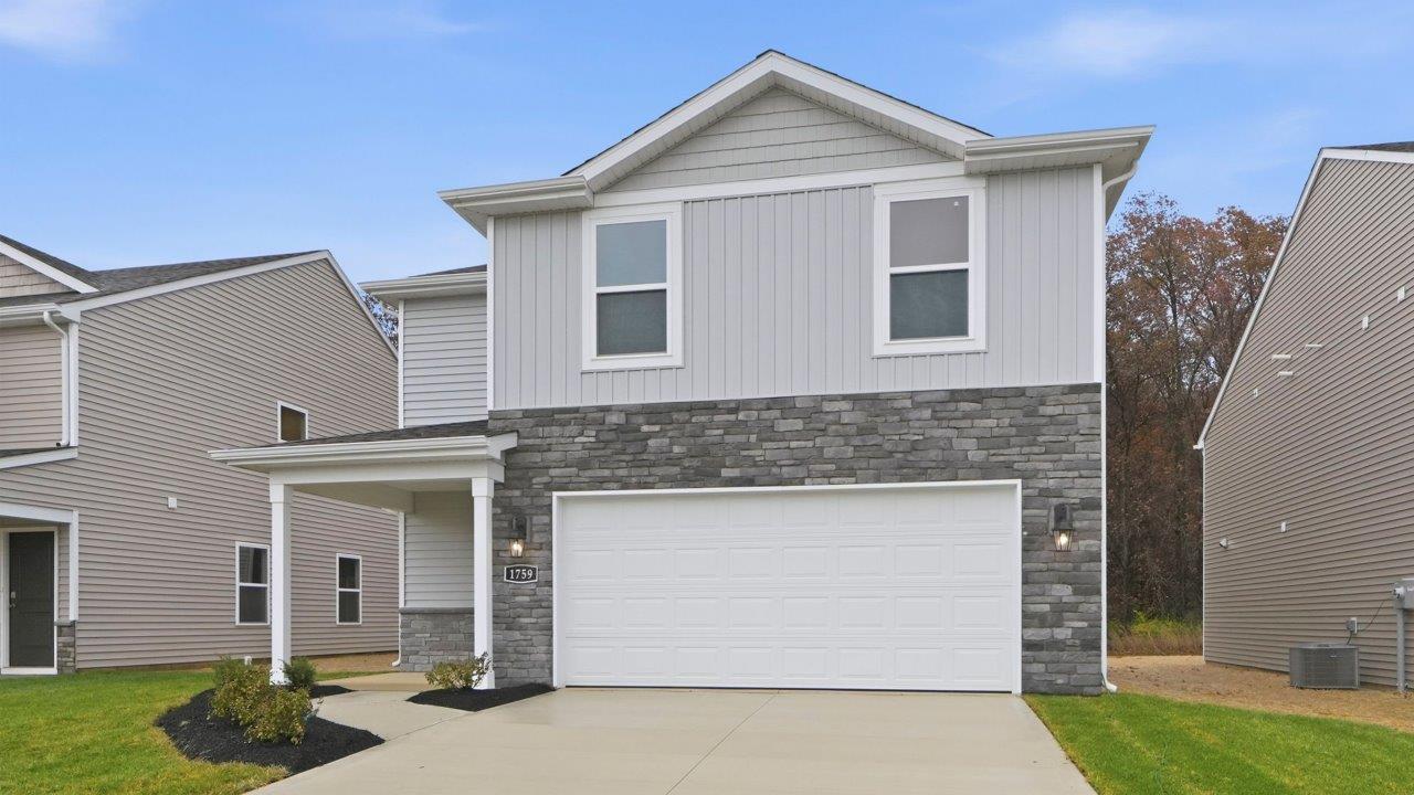 parlor bluffs pine exterior with sod, landscaping, and 2 car garage
