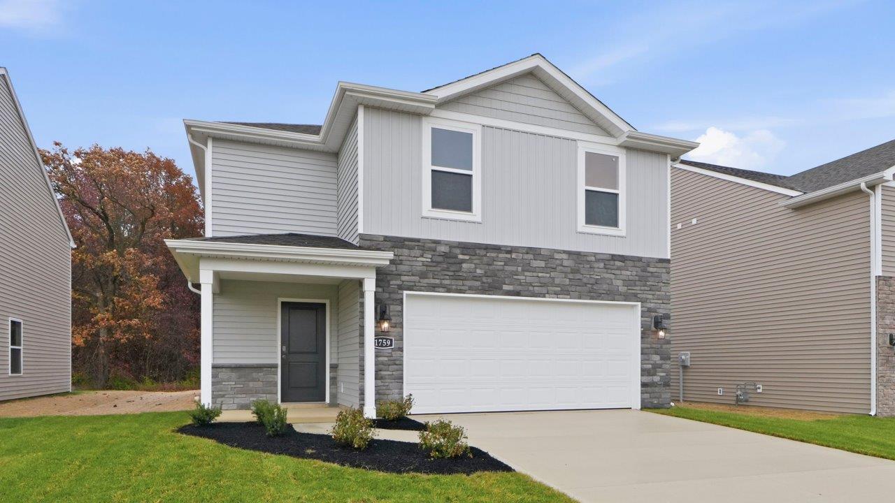 parlor bluffs pine exterior with sod, landscaping, and 2 car garage