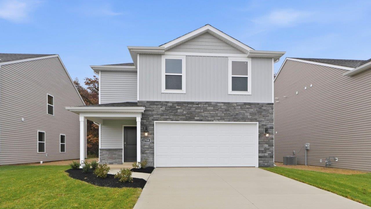 parlor bluffs pine exterior with sod, landscaping, and 2 car garage