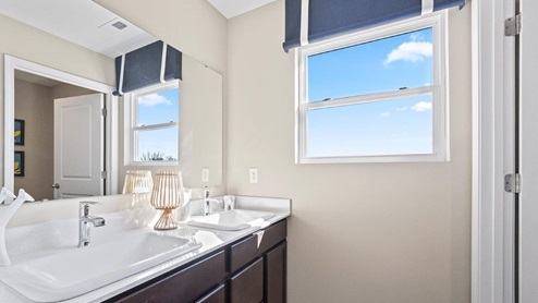 marcella model home bathroom with tub shower and dual sink