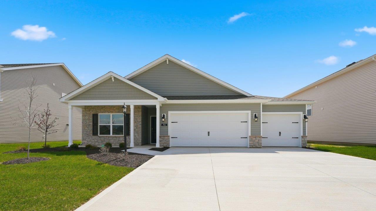 Marcella home exterior ranch with 3 car garage and landscaping