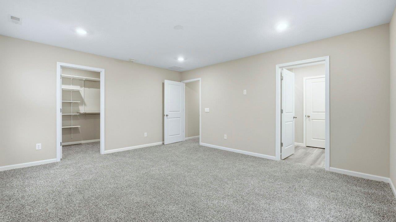 primary bedroom with ensuite bath and closet