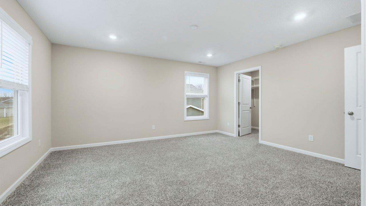 primary bedroom with ensuite bath and closet