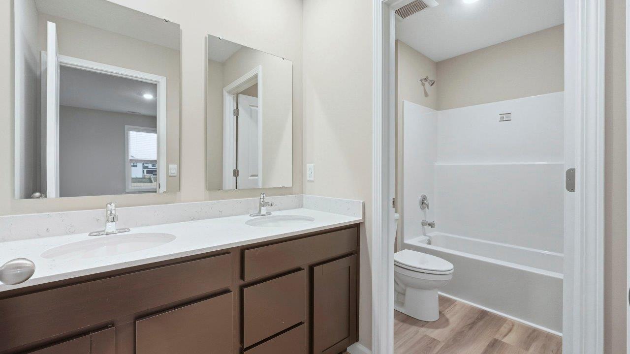 full bath with duals sinks and private tub shower