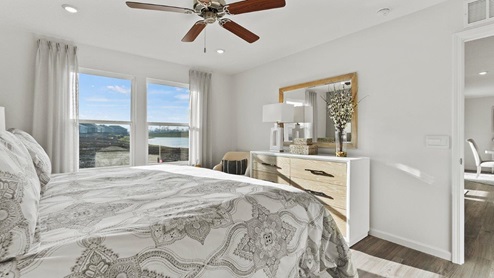 Estates at Signal Ridge Chatham model home main bedroom with 52" ceiling fan included and LVP flooring