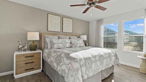 Estates at Signal Ridge Chatham model home main bedroom with LVP flooring and white walls