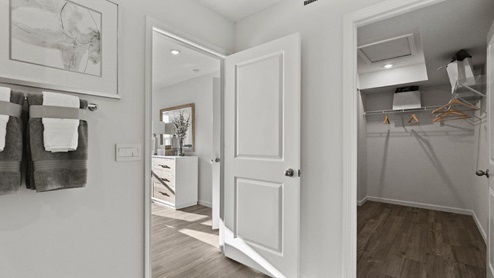 Estates at Signal Ridge Chatham model home walk in closet with LVP flooring and wire shelving