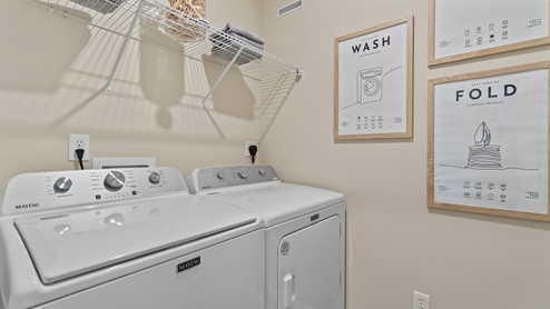 Estates at Signal Ridge Chatham model home laundry room with shelving