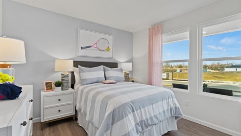 Estates at Signal Ridge Chatham model home bedroom 3 with two windows with LVP flooring
