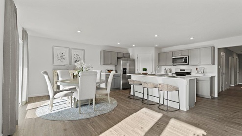 Estates at Signal Ridge Chatham model open floor plan kitchen and dining room with LVP flooring throughout