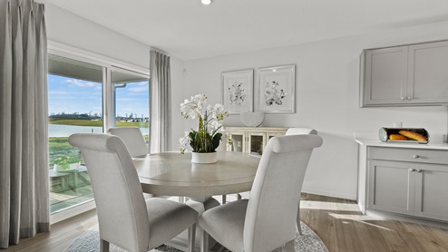 Estates at Signal Ridge Chatham model dining room with sliding glass door leading the patio and the backyard