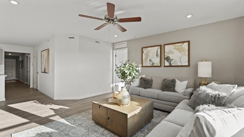 Estates at Signal Ridge Chatham model living room with 52" ceiling fan and LVP flooring