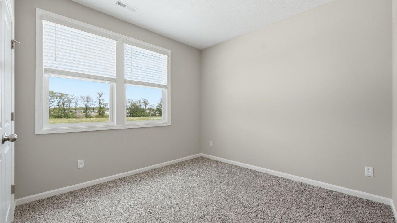 estates at signal ridge harmony villa bedroom with carpet flooring and ensuite closet
