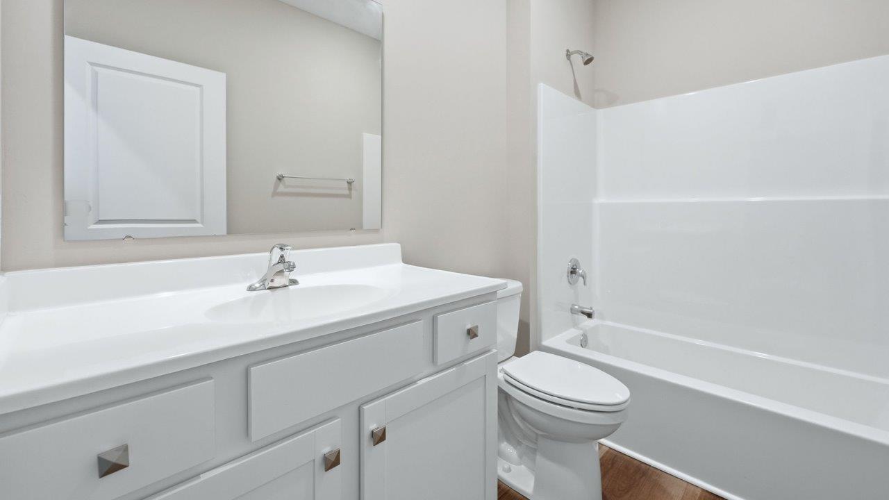estates at signal ridge harmony villa full bathroom with single vanity sink and tub shower