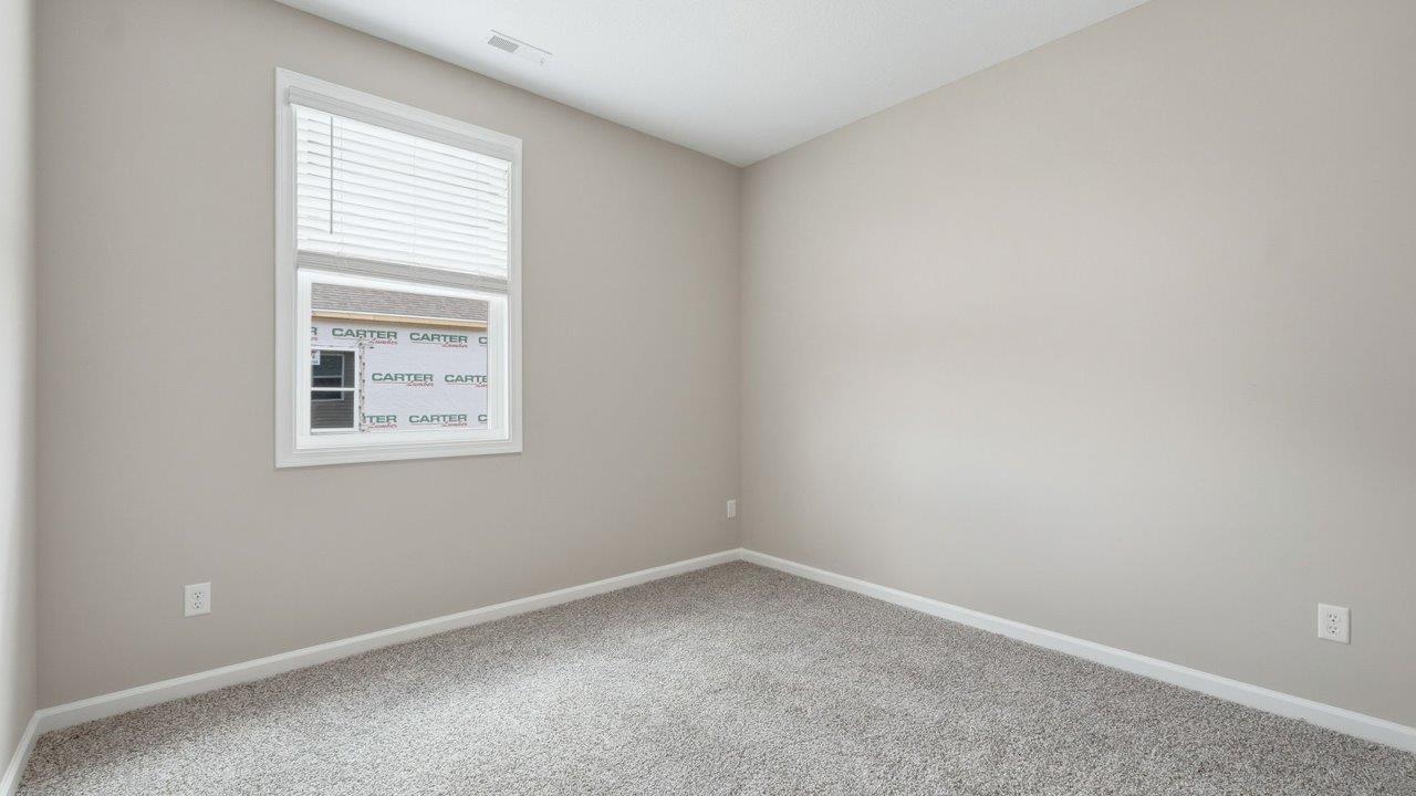estates at signal ridge harmony villa bedroom with carpet flooring and ensuite closet