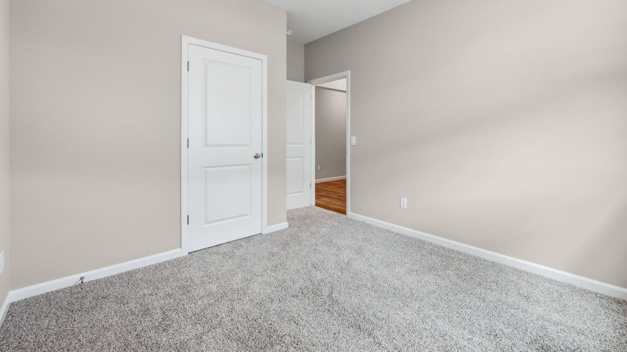 estates at signal ridge harmony villa bedroom with carpet flooring and ensuite closet