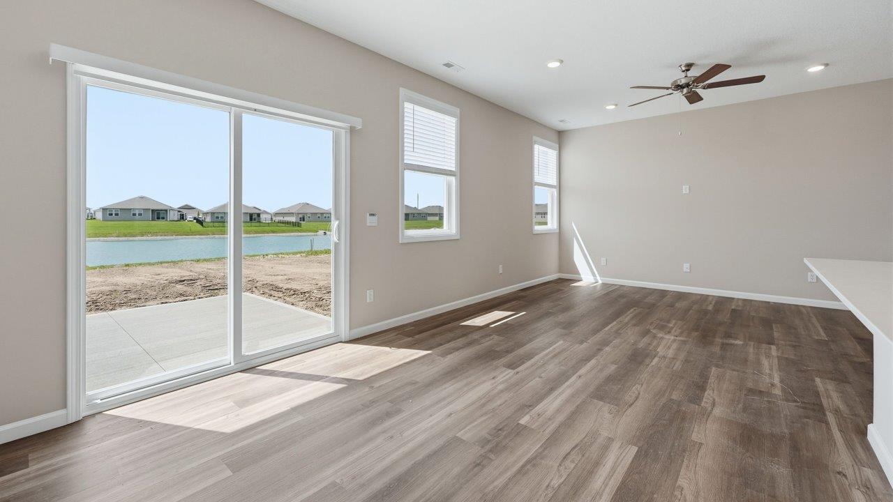 estates at signal ridge harmony villa dining space with lvp flooring and sliding glass door to backyard