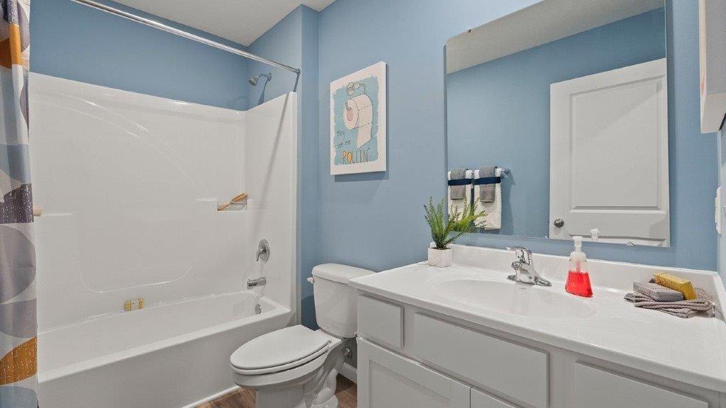 full bathroom with single sink vanity and tub shower