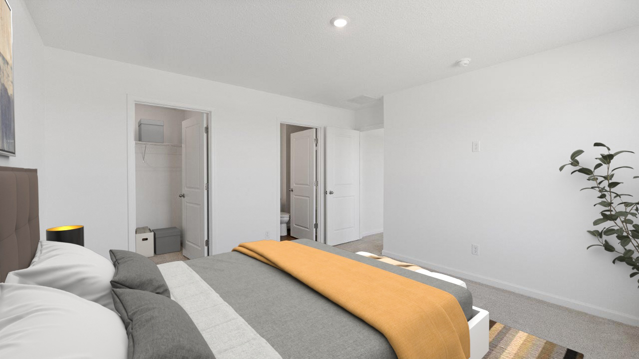 primary bedroom with 2 windows, white walls, carpet flooring, and ensuite bath and closet