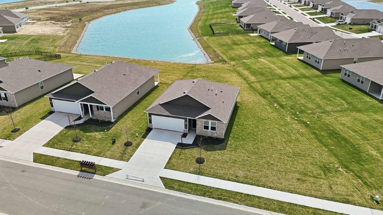estates at signal ridge aldridge exterior with sod yard, landscaping, 2 car garage, and pond homesite