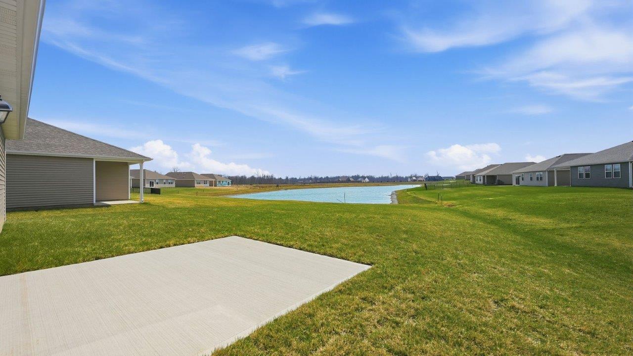 estates at signal ridge aldridge exterior with sod yard, landscaping, 2 car garage, and pond homesite