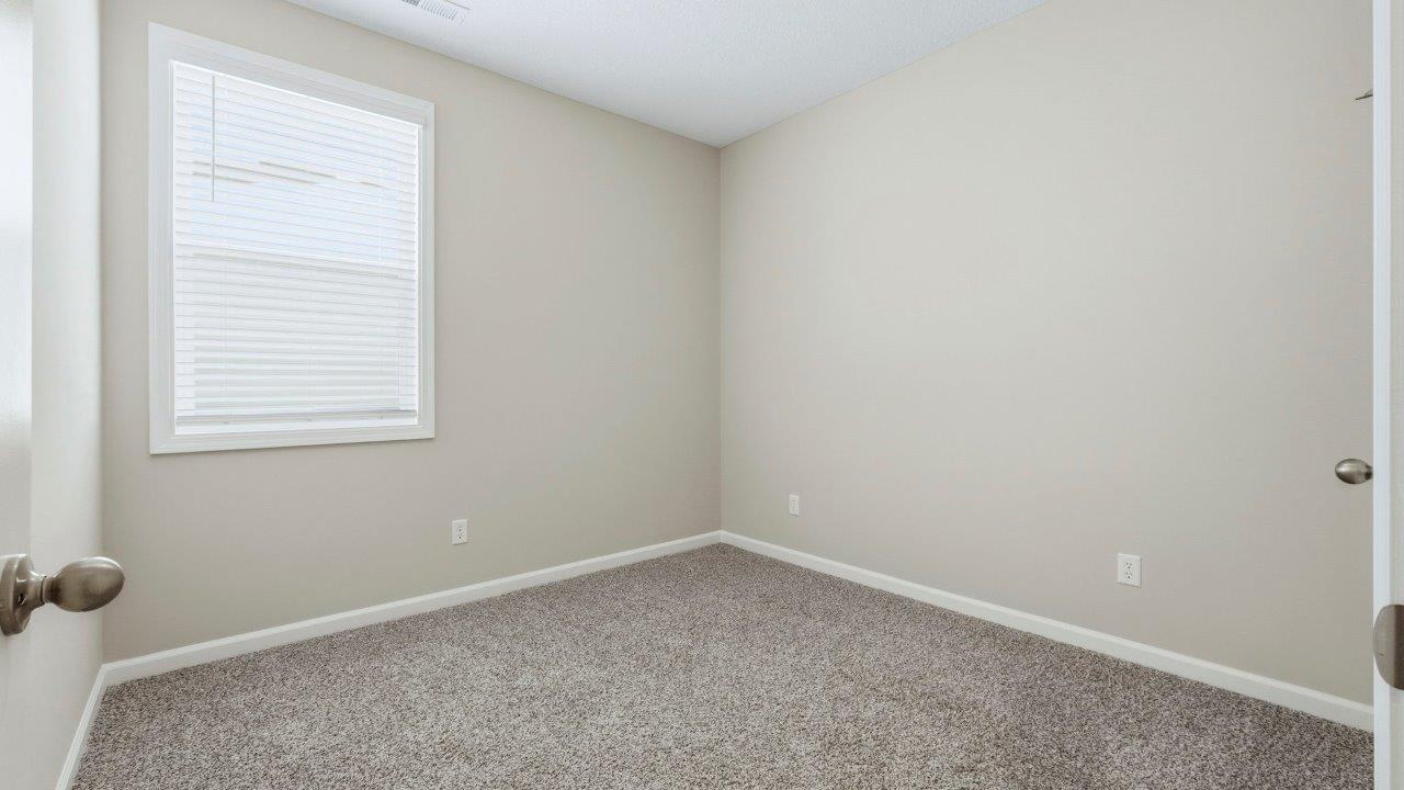 bedroom 3 with carpet and closet