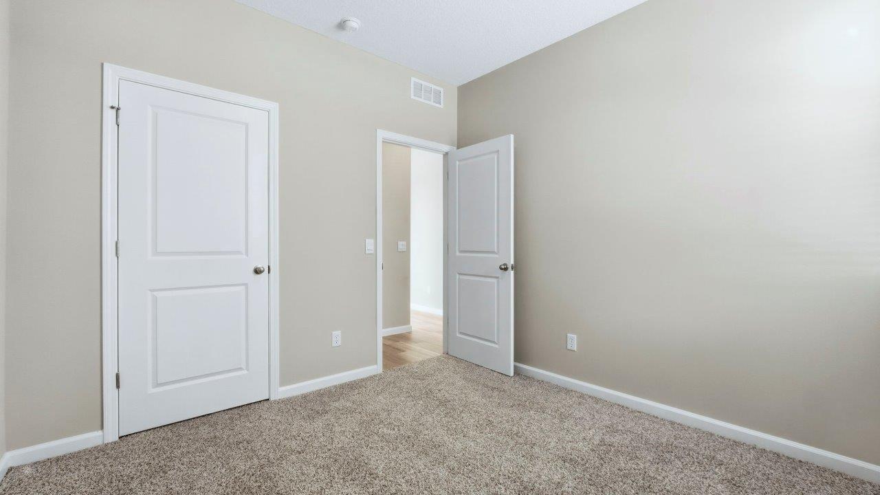 bedroom 3 with carpet and closet