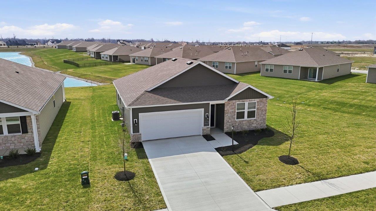 estates at signal ridge aldridge exterior with sod yard, landscaping, 2 car garage, and pond homesite