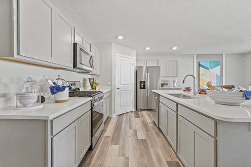Timber Creek Chatham Model Home - kitchen with grey cabinetry with 30" upper cabinets.