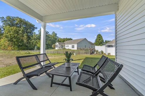 Timber Creek Chatham Model Home - covered patio on 12x12 concrete and sodded backyard.