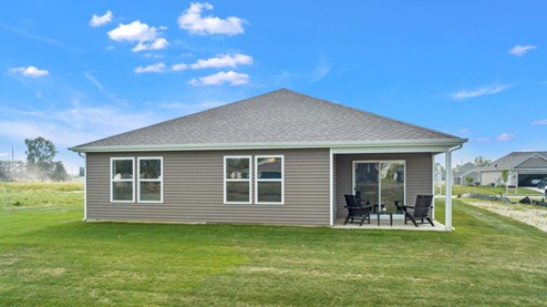 fawn creek estates model home rear exterior with covered patio