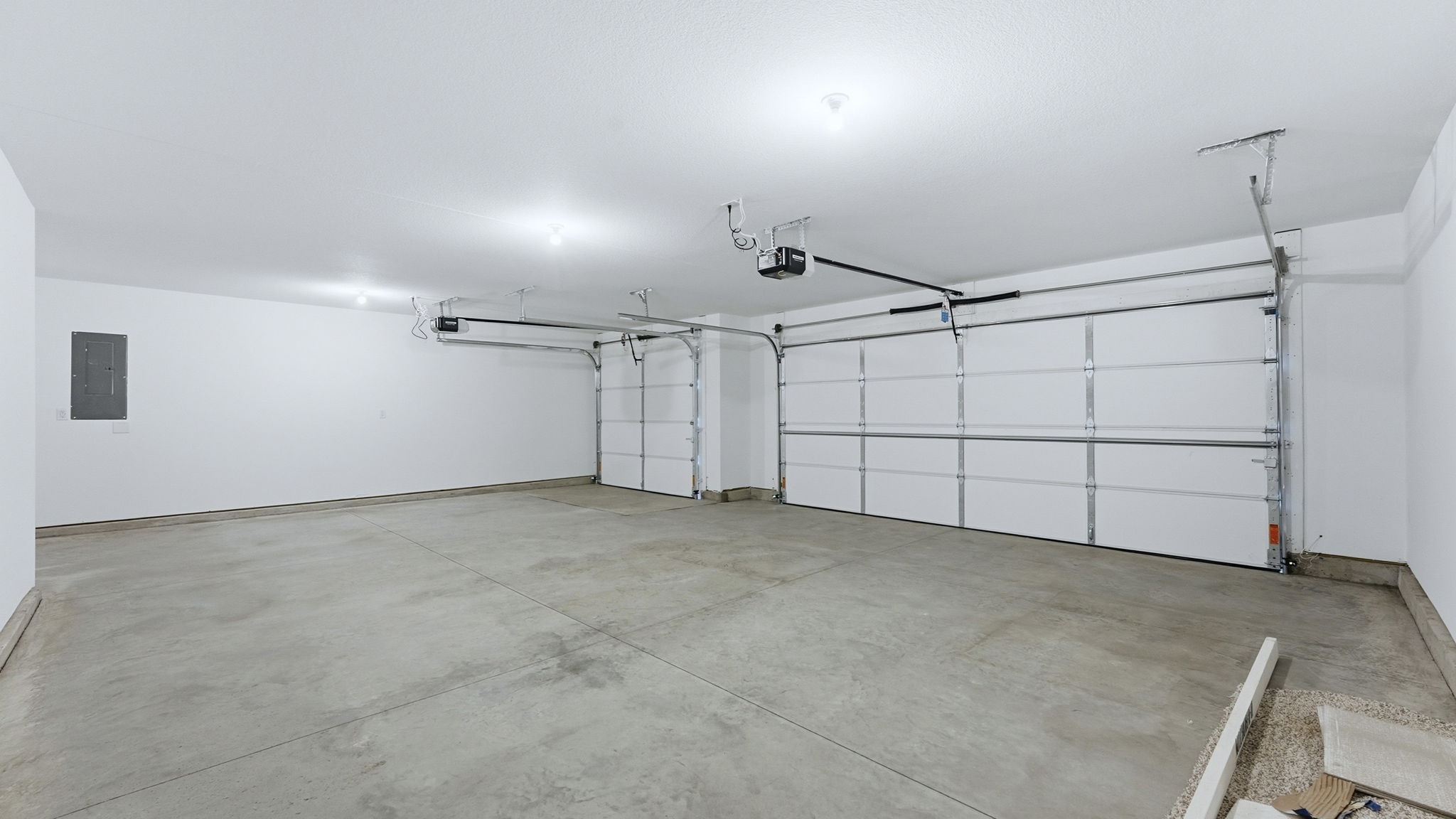 3 car garage interior with drywalled interior