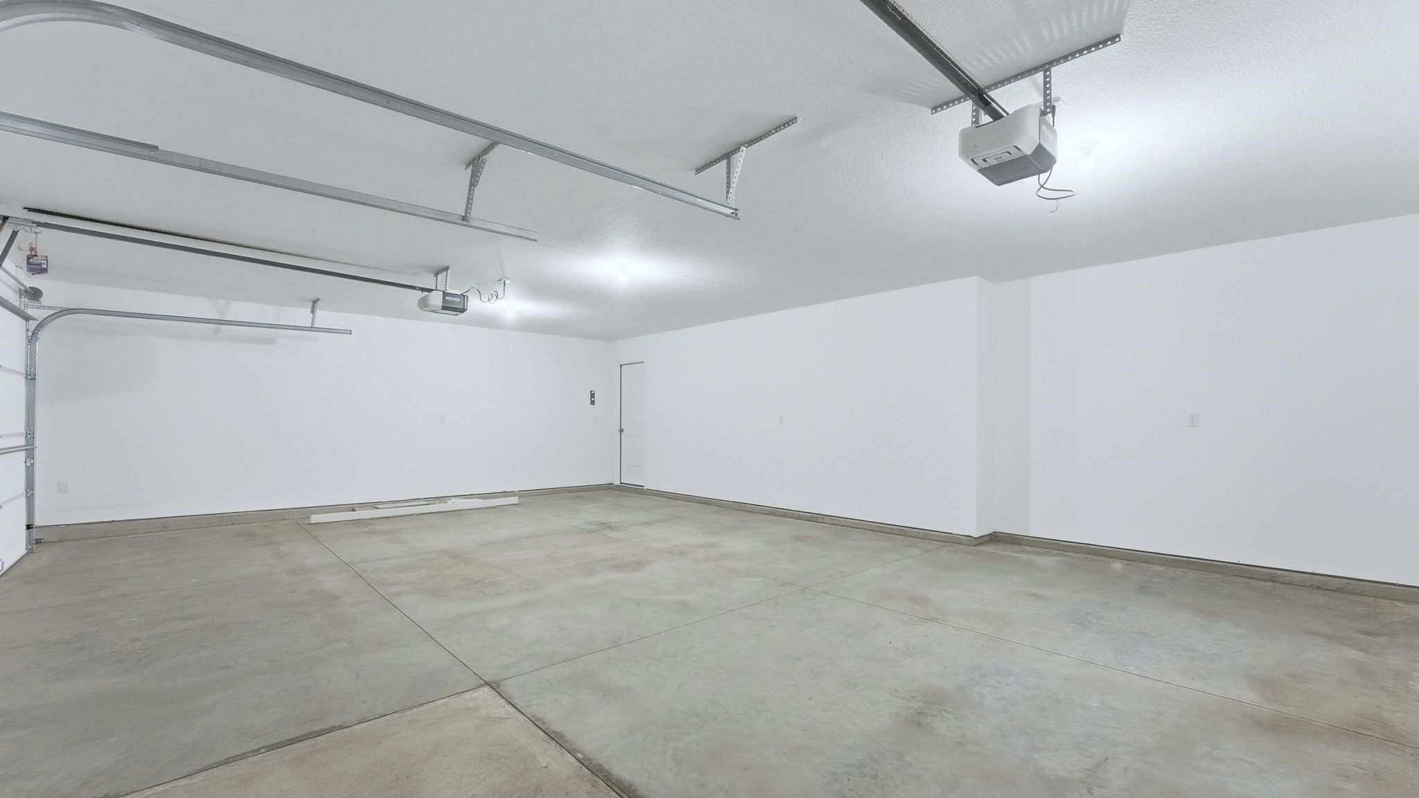 3 car garage interior with drywalled interior