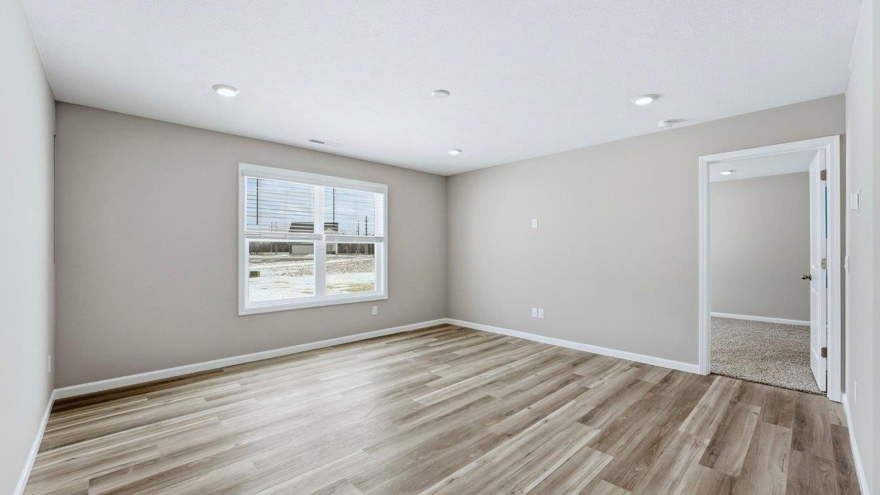 living room with lvp flooring, popular grey walls, 2 windows